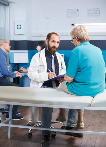 Aged,Woman,With,Physical,Injuries,Receives,Advice,From,Male,Practitioner Aged,Woman,With,Physical,Injuries,Receives,Advice,From,Male,Practitioner
