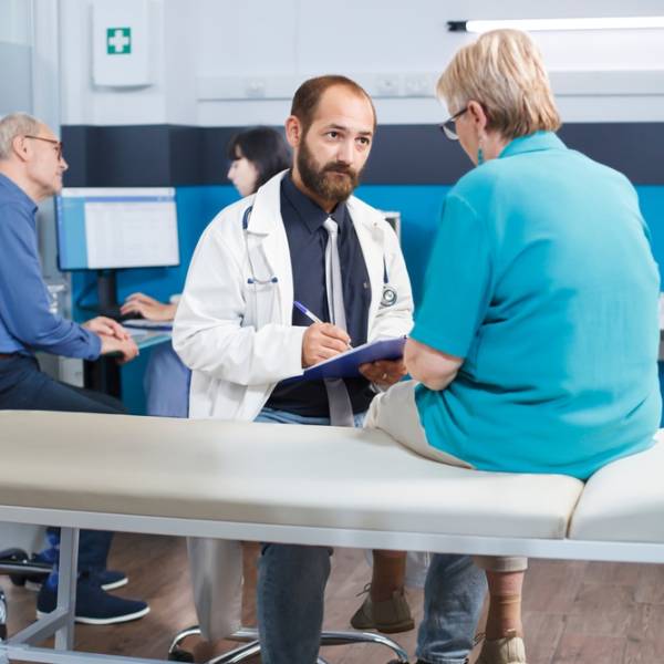 Aged,Woman,With,Physical,Injuries,Receives,Advice,From,Male,Practitioner Aged,Woman,With,Physical,Injuries,Receives,Advice,From,Male,Practitioner